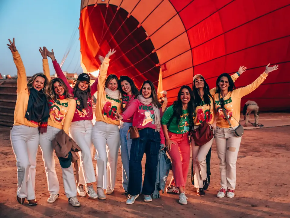 A group of guests celebrating beside a balloon