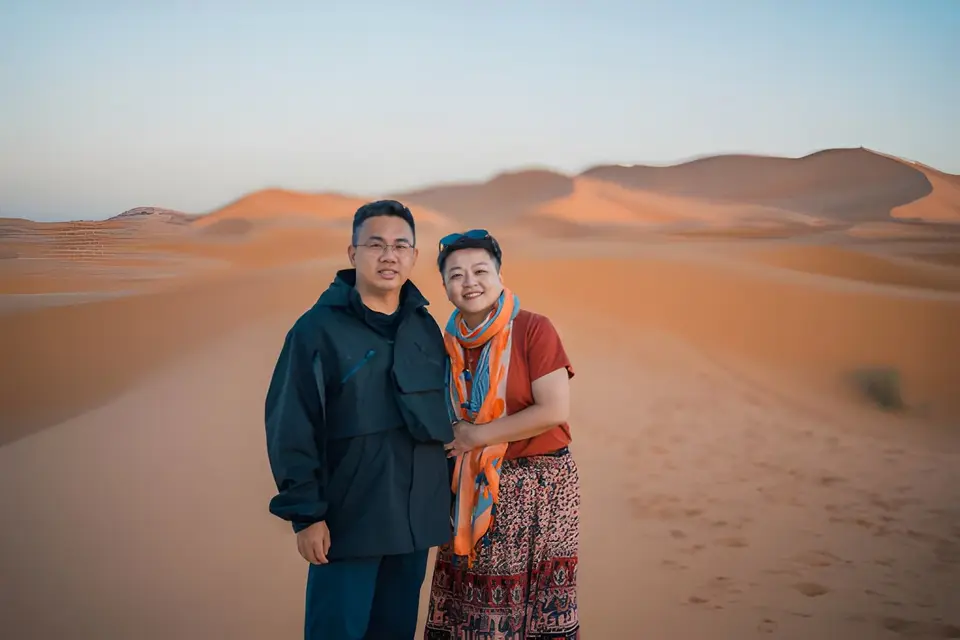A couple in the dunes at golden hour