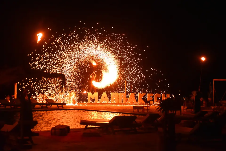 A fire show at a desert camp at night