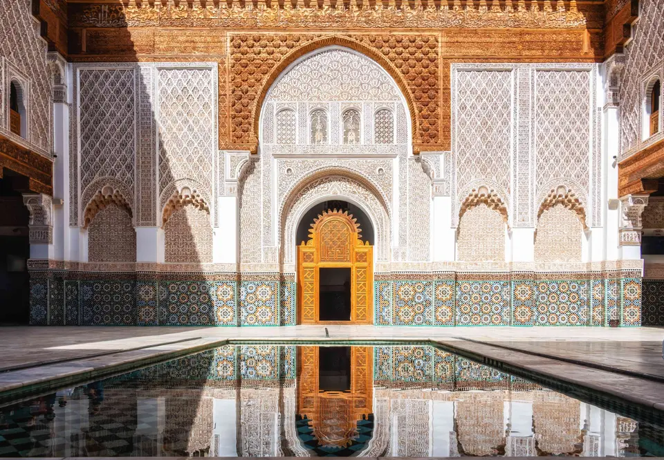 The Ben Youssef Madrasa reflected in its courtyard pool, Marrakech