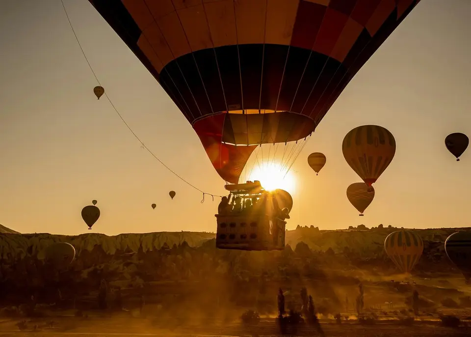 A balloon's burner against the sunrise