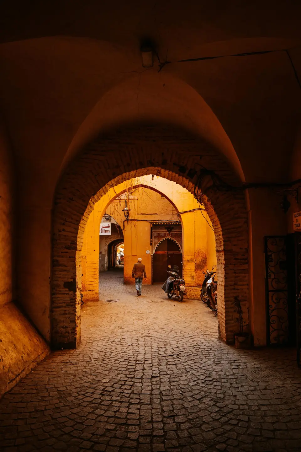 A lamplit medina archway at night